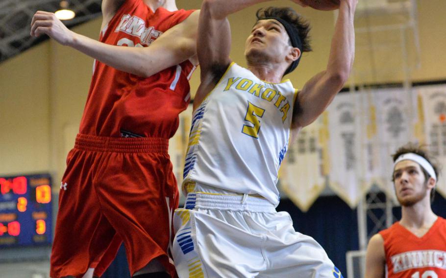 Yokota's Shota Sprunger pulls up to shoot against Nile C. Kinnick's Dominic Rosa during Saturday's DODDS Japan boys final, won by the Panthers 62-52.