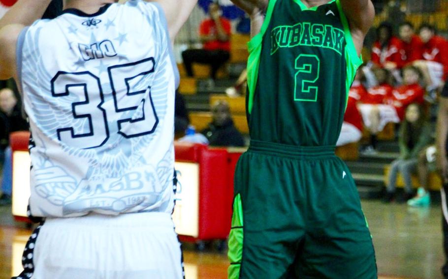 Kubasaki's Jacob Green shoots over CAJ's Rick Handa during Kubasaki's 67-21 Far East Tournament round robin victory Feb. 15, 2016 at Camp Foster in Okinawa, Japan.  