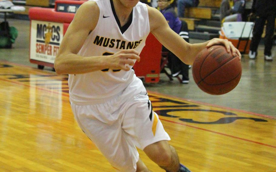 ASIJ's Ian McGuire penetrates during ASIJ's 64-62 Far East Tournament round robin overtime loss to the American School of Bangkok Feb. 15, 2016 at Camp Foster in Okinawa, Japan.  