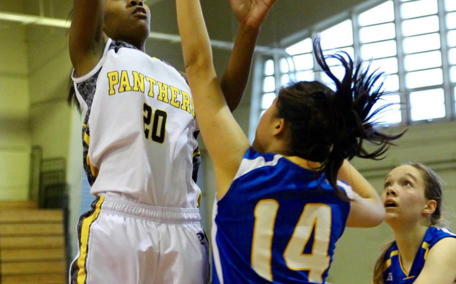 Kadena's Brenda Gulley shoots over CAJ's HaYoung Chung during Kadena's 42-11 Far East Tournament round robin victory Feb. 15, 2016 at Camp Foster in Okinawa, Japan.  