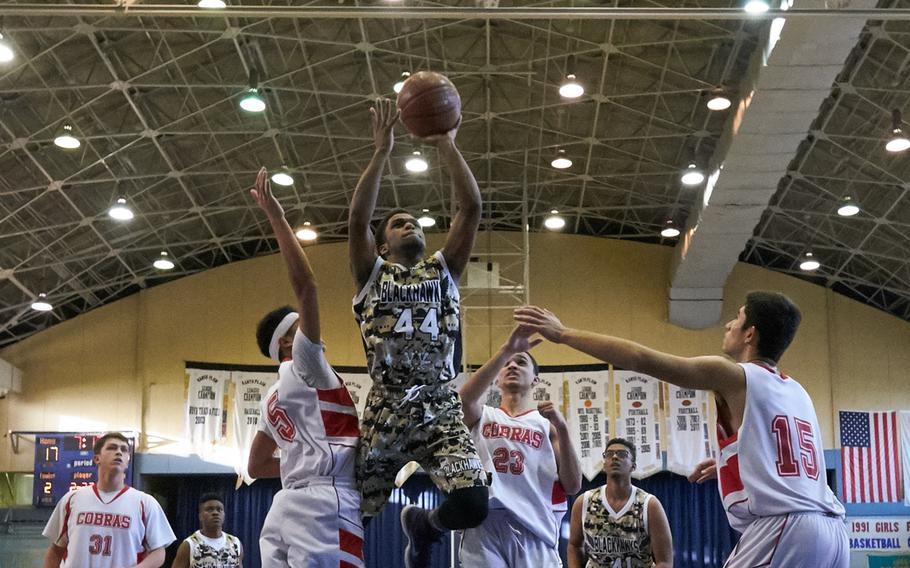 Humphreys' Malik Dampier splits the King defense during the Far East Tournament Boys Division II pool play at Yokota Air Base, Japan, on Tuesday, Feb. 16, 2016.  