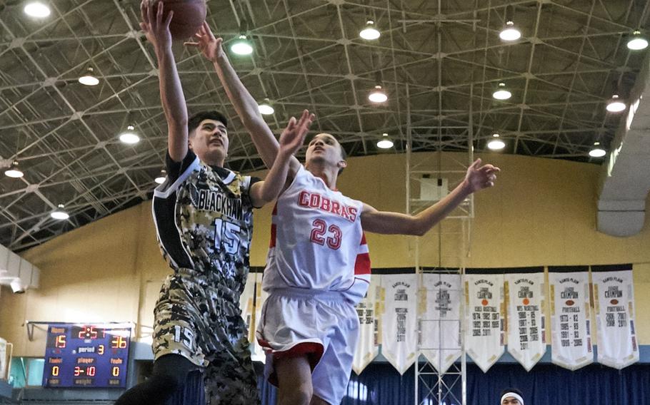 Humphreys' Omar Lopez attempts a fast break layup while defended by King's Seth Hudson during the Far East Tournament Boys Division II pool play at Yokota Air Base, Japan, on Tuesday, Feb. 16, 2016.  