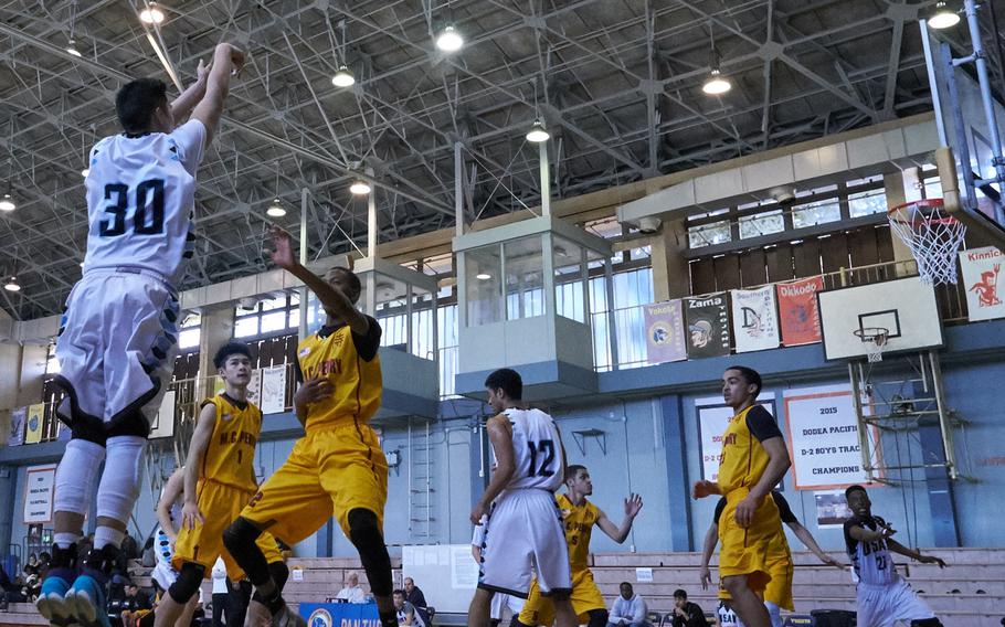 Osan's Justin Maglalang shoots a corner three over the M.C. Perry defense during the Far East Tournament Boys Division II pool play at Yokota Air Base, Japan, on Tuesday, Feb. 16, 2016.  