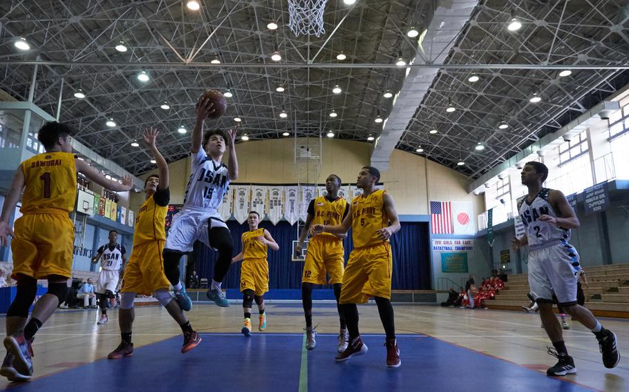 Osan's Sung DeAngelo splits the M.C. Perry defense during the Far East Tournament Boys Division II pool play at Yokota Air Base, Japan on Tuesday, Feb. 16, 2016.  