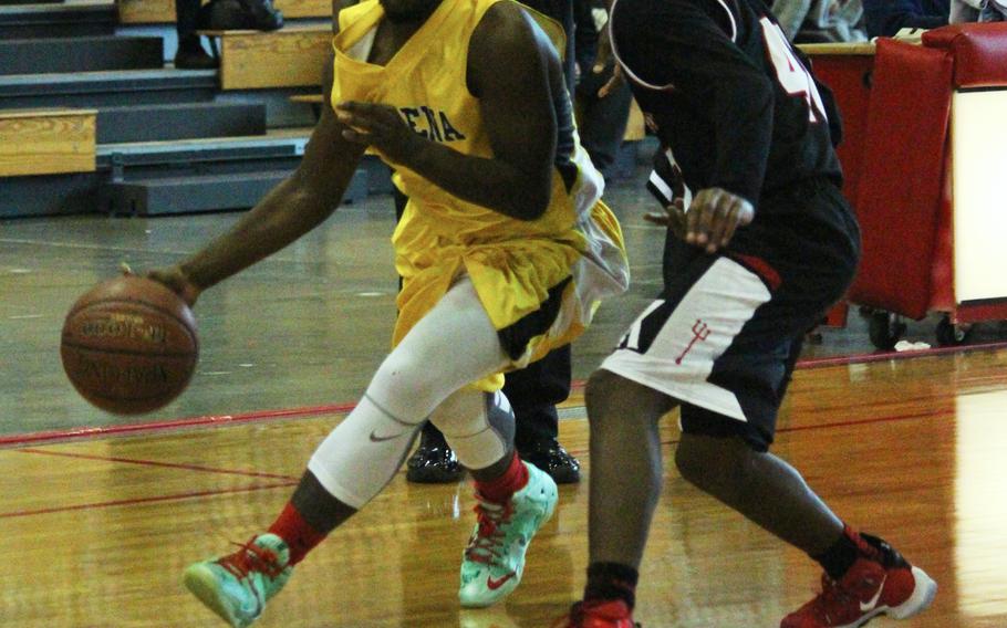 Kadena's Jahron Mitchell drives past Kinnick's Jacob Germany during the Far East Tournament Boys Division I pool play at Camp Foster in Okinawa, Japan, on Tuesday, Feb. 16, 2016.  