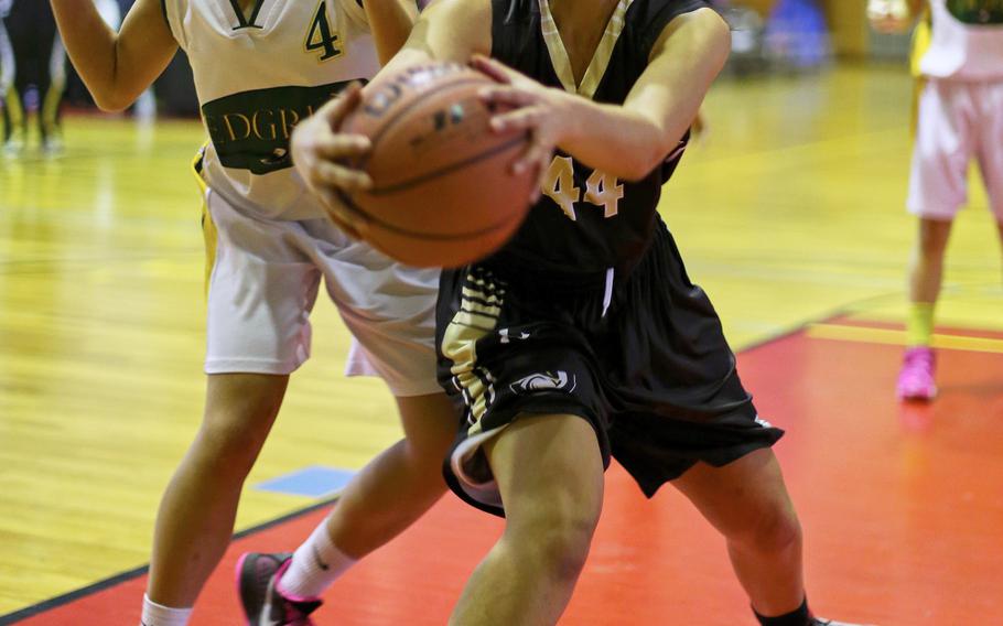 Edgren's Nina Robertson and Humphreys' Sydney Wilson try to gain control of a loose ball during the Far East Tournament Girls Division II pool play at Marine Corps Air Station Iwakuni, Japan on Tuesday, Feb. 16, 2016.  