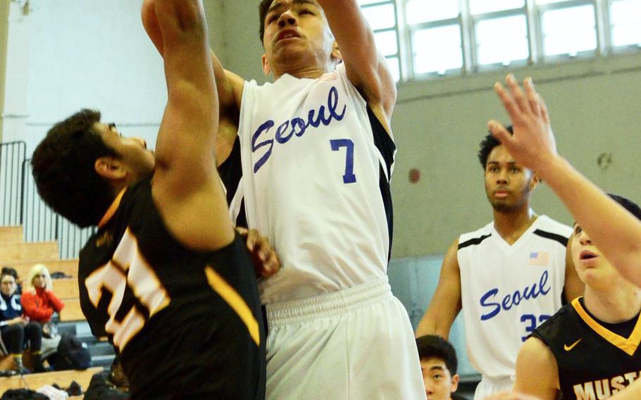 Seoul American's Quintin Metcalf shoots over American School in Japan's Mahaad Ahktar during the Far East Tournament Boys Division I pool play at Camp Foster in Okinawa, Japan on Tuesday, Feb. 16, 2016.  
