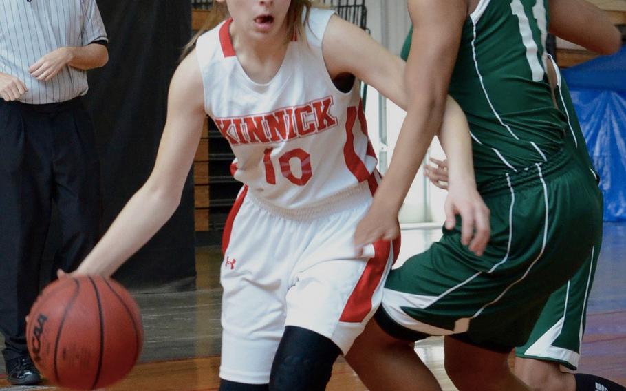 Kinnick's Kailee Rucker drives past Kubasaki's Josie Daffin during the Far East Tournament Girls Division I pool play at Camp Foster in Okinawa, Japan on Tuesday, Feb. 16, 2016.  