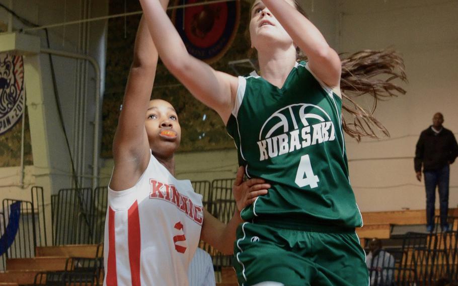 Kubasaki's Chloe Stevens shoots over Kinnick's Jade McGinnis during the Far East Tournament Girls Division I pool play at Camp Foster in Okinawa, Japan on Tuesday, Feb. 16, 2016. 