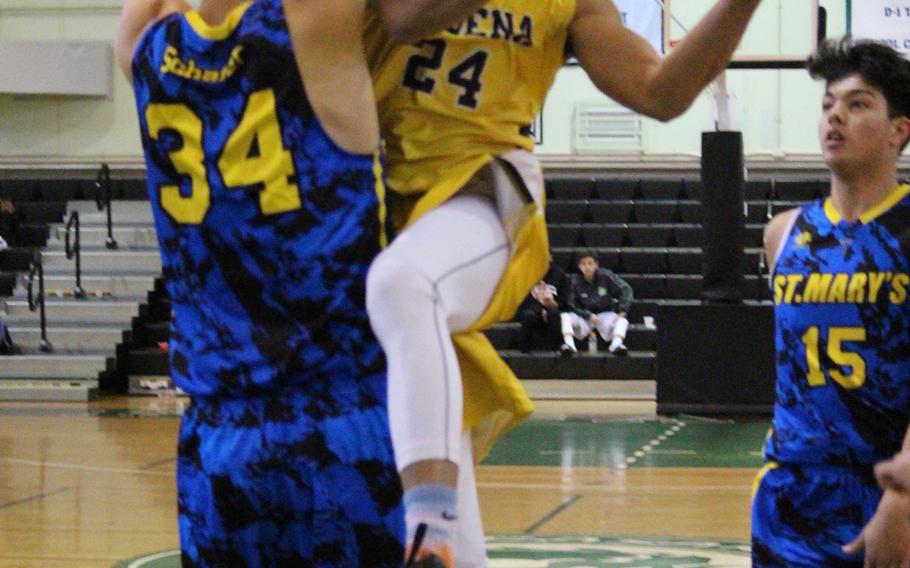 Kadena's Justin Williams tries to find space around St. Mary's Avi Schaefer during the Far East Boys Division I Tournament on Wednesday, Feb. 17, 2016 at Foster Field House in Okinawa, Japan.
