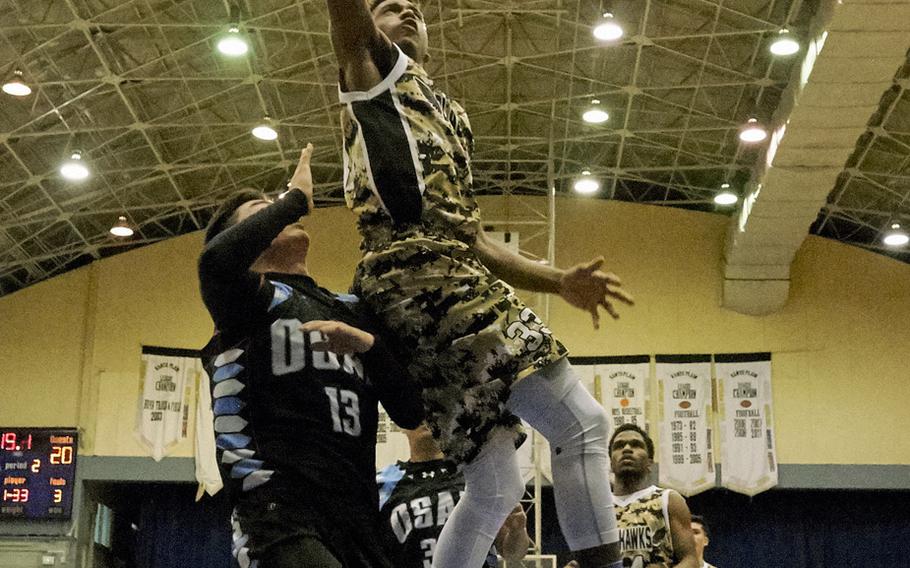 Humphreys' Nate Hellams beats Osan's Mathew Burbee on a fast break during the Far East Boys Division II Tournament on Wednesday, Feb. 17, 2016 at Yokota Air Base, Japan.