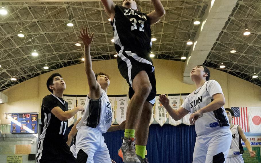 Zama's Joshu Nay scores two of his 33 points during the Far East Tournament Boys Division II ninth-place game against Zion Christian on Thursday, Feb. 18, 2016 at Yokota Air Base, Japan.  