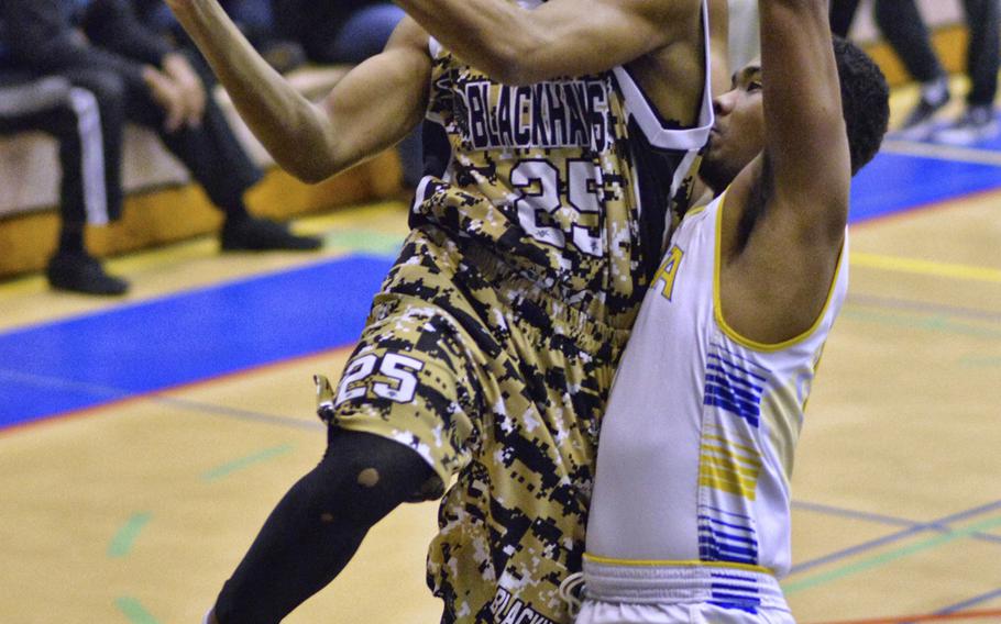 Humphreys junior Bashr Edmonds looks to pass while guarded by Yokota' senior Marcus Henagan.
