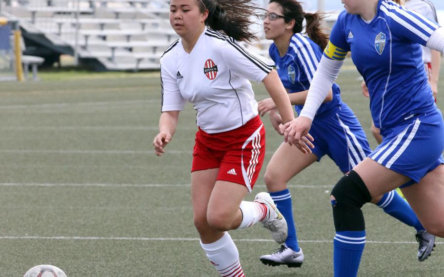 Kinnick midfielder Kiralyn Kawachi splits the Yokota defense for one of her two goals in the 2015 Far East Division I Tournament runner-up Red Devils' season-opening 3-1 win over the reigning Far East Division II Tournament champion Panthers.
