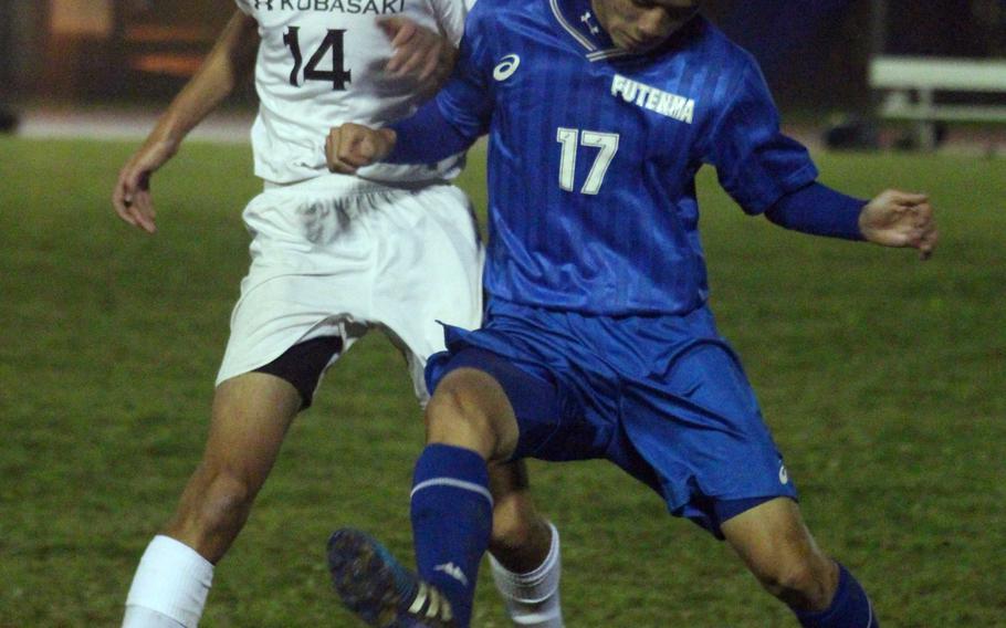 Kubasaki's Hank Snyder tangles with a Futenma player for the ball during Wednesday's boys soccer match, won by the Dragons 4-2.