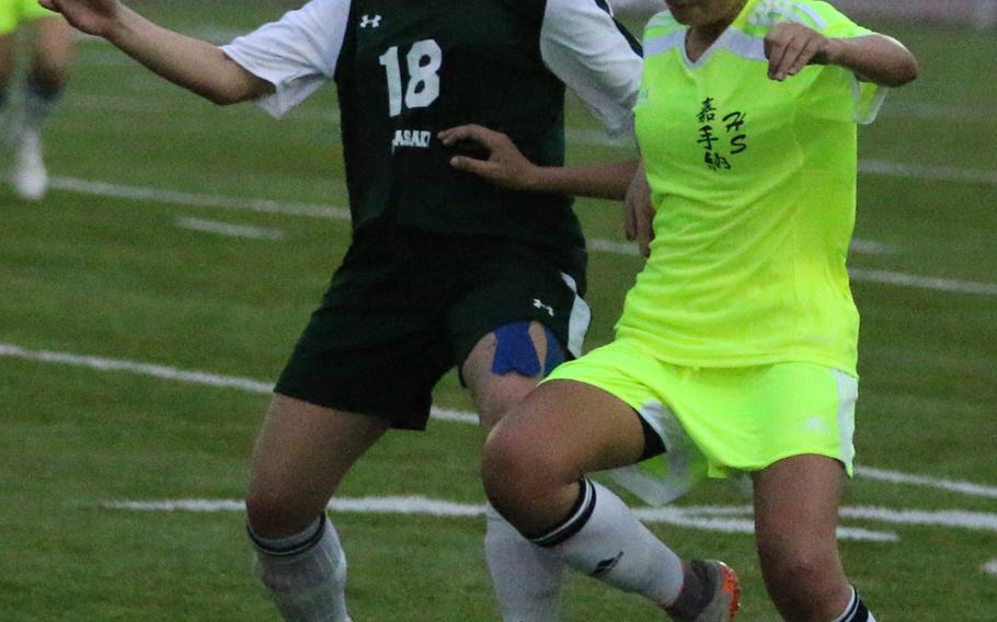 Kubasaki's Reiko Lemasters and Kadena's Adri Gomez battle for the ball during Wednesday's girls soccer match, won by the two-time defending Far East Division I champion Dragons 1-0.