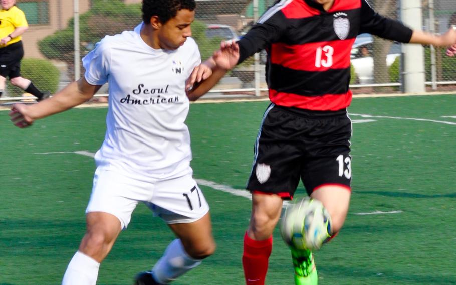 Seoul American's Niko Russey and Seoul Foreign's Paul Yoon battle for the ball during Wednesday's boys soccer match, won by the Crusaders 3-1.
