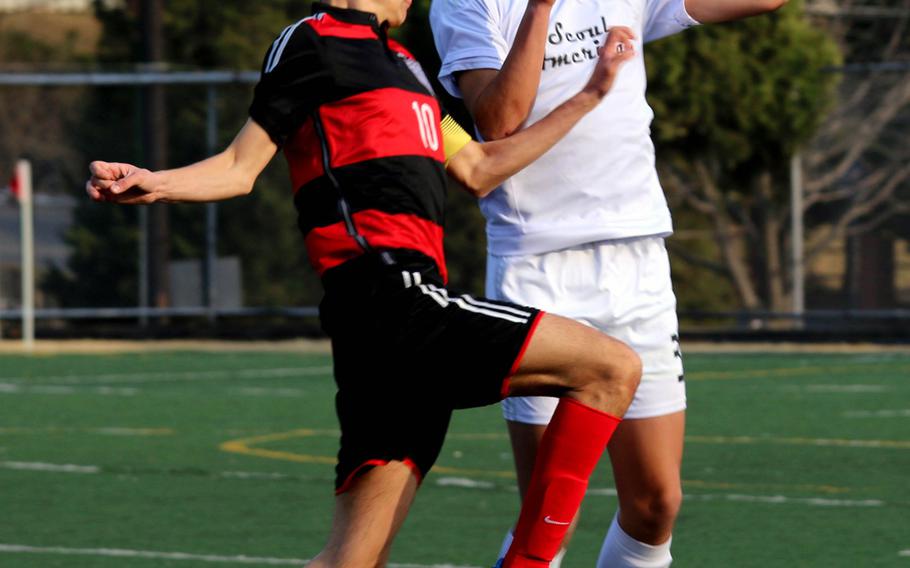 Seoul American's Julian Ruiz and Seoul Foreign's Francesco Luraschi go up to head the ball during Wednesday's boys soccer match, won by the Crusaders 3-1.