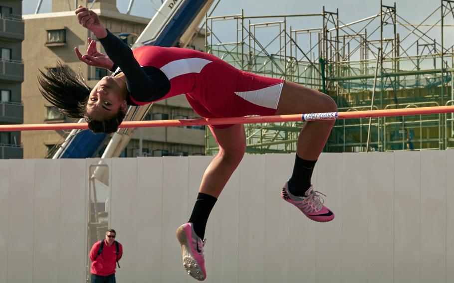 Kinnick's Exotica Hall clears 1.55 meters in the high jump to win the event during Saturday's Kanto Plain track and field meet at Yokota.