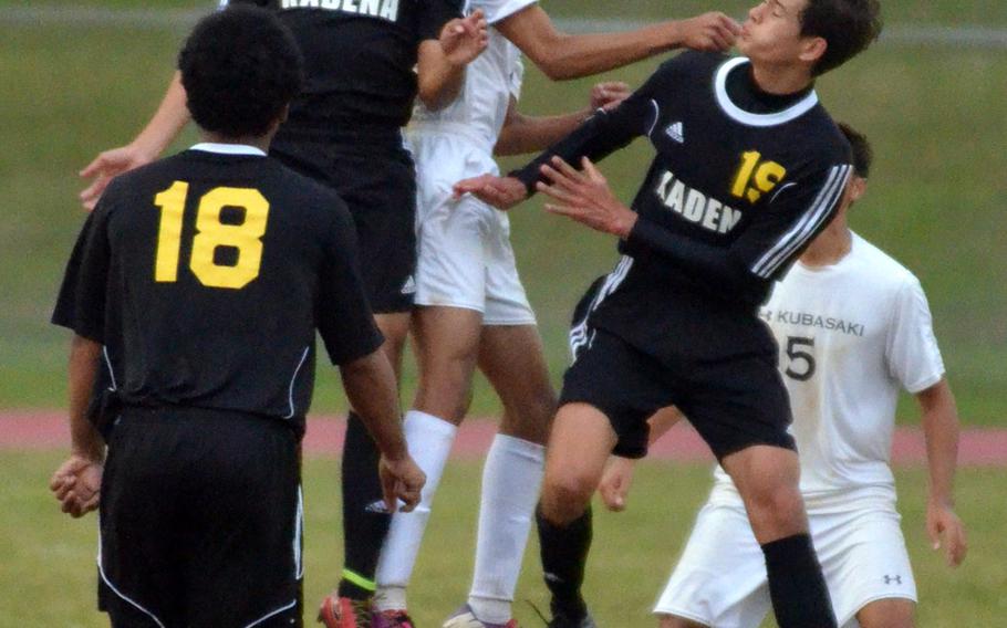 Kadena's Austin Sahagun heads the ball next to Kubasaki's Ryo Elliot and surrounded by teammates Bryan Vaden, left, and Guy Renquist during Wednesday's boys soccer match, won by the Dragons 2-0.