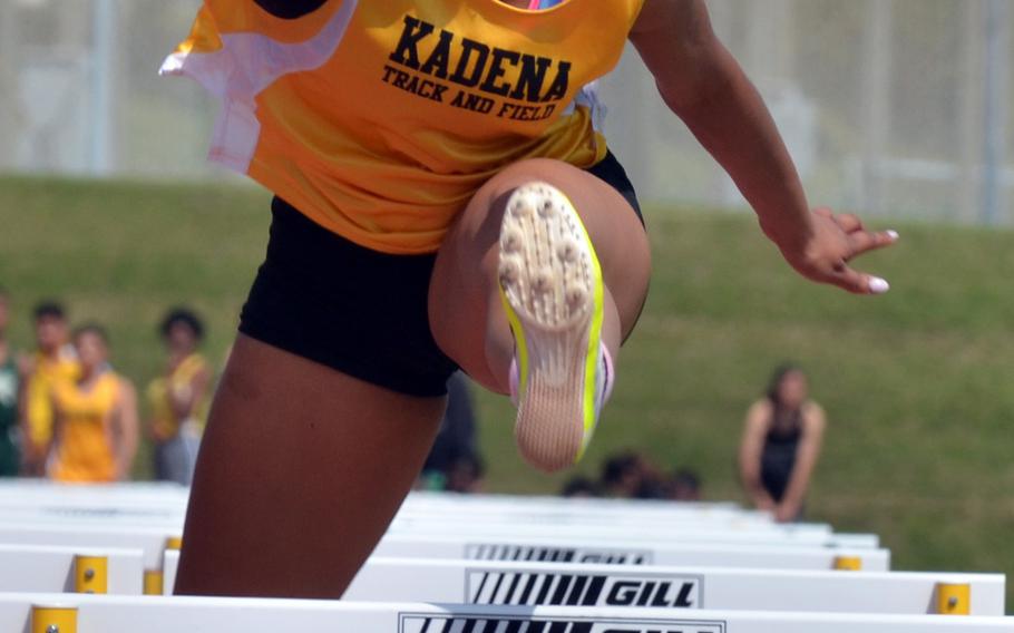 Kadena's Tiarrah Edwards clears a hurdle in the 100-meter hurdles race during Saturday's Okinawa track and field meet. Edwards won with a time of 16.37 seconds.