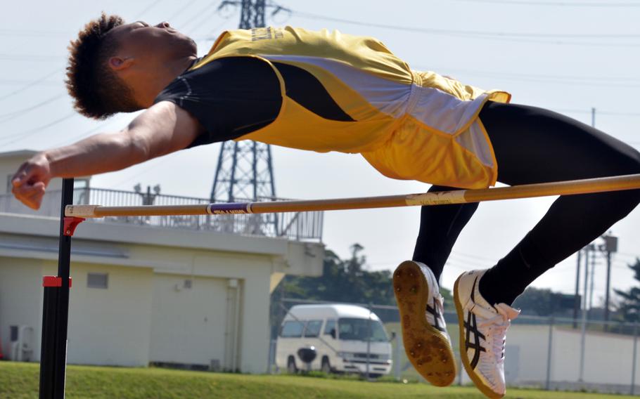 Kadena's Donte Savoy clears the bar in the high jump during Saturday's Okinawa track and field meet. Savoy won for the second straight week at a height of 6 feet.