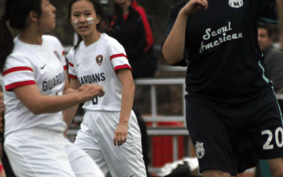 Seoul American's Fran Vido heads the ball away from Yongsan International-Seoul defenders during Wednesday's girls soccer match, won by the Guardians 4-2.

























