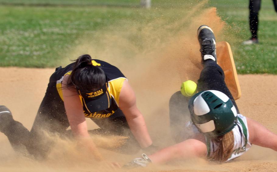 Kubasaki baserunner Madison Richardson kicks up a dust storm -- and second base -- as she slides in safely as American School In Japan shortstop Soo Park can't handle the throw during Thursday's doubleheader opener. The Dragons won both games by run rule. Richardson batted 5-for-9 with three RBIs in the two games.