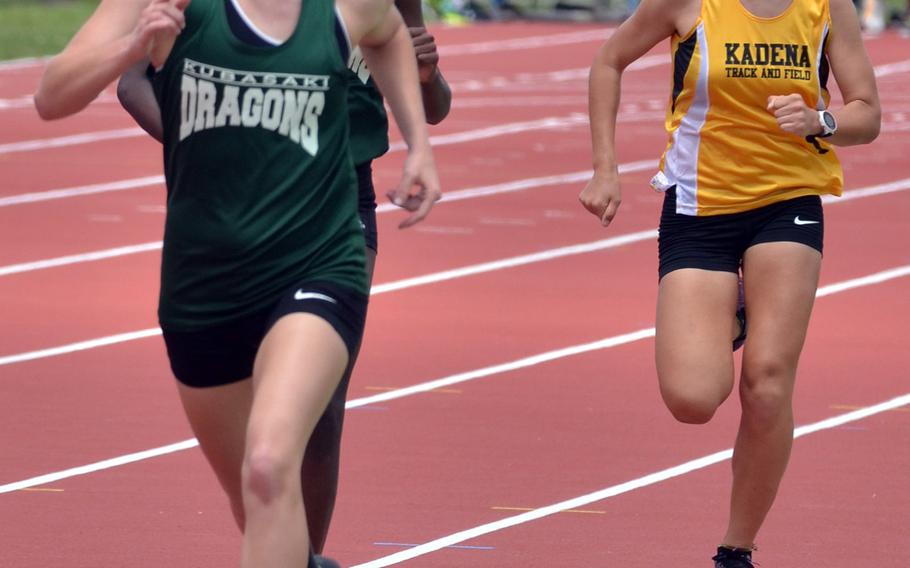 Kubasaki's Rachel Carson leads teammate Jacqueline Clardy-Josephs and Kadena's Wren Renquist down the home stretch of the 1,600, which Carson won along with the 800.