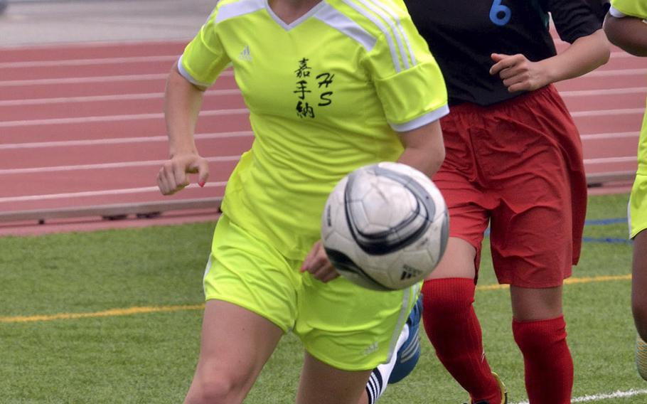 Kadena's Katrina Rhodehouse chases the ball past the Naha Shogyo defense during Saturday's girls soccer match, won by the Panthers 6-0.