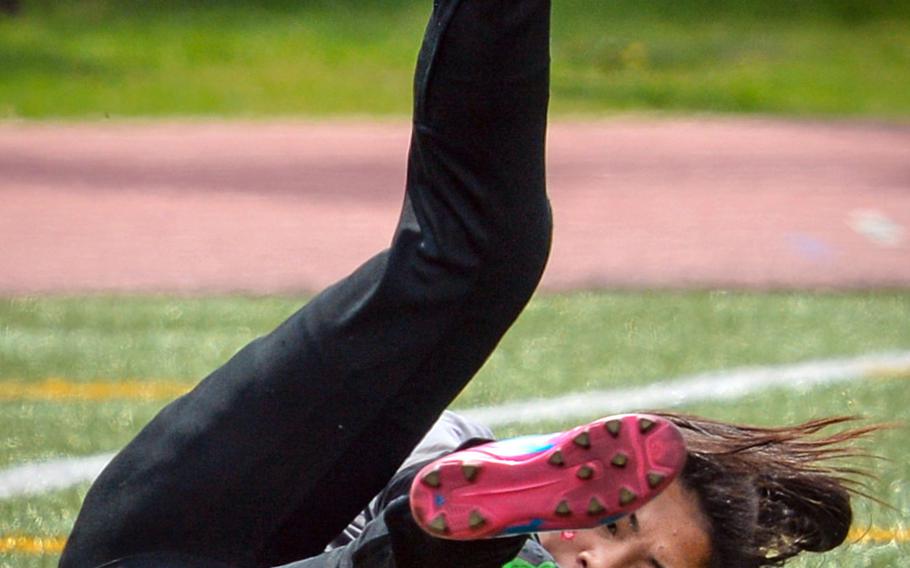 Perry goalkeeper Angel Cadavos sprawls to make a save against Kinnick during Saturday's DODEA-Japan girls soccer tournament final, won by the Red Devils 5-2.