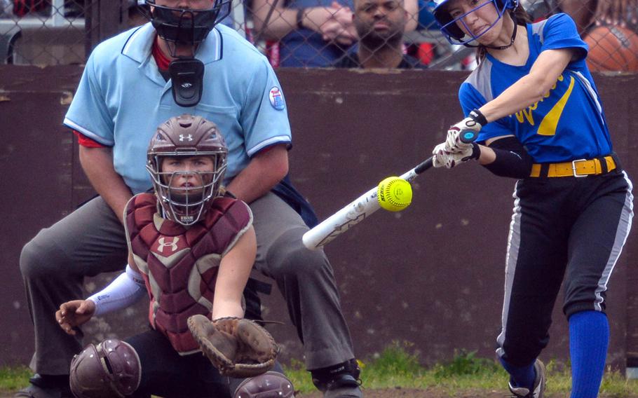Yokota's Kaia Austin leans into a delivery as Zama catcher Ally Chiarenza and umpire Kelly Cook watch during Saturday's DODEA-Japan softball tournament final, won by the Panthers 13-3.