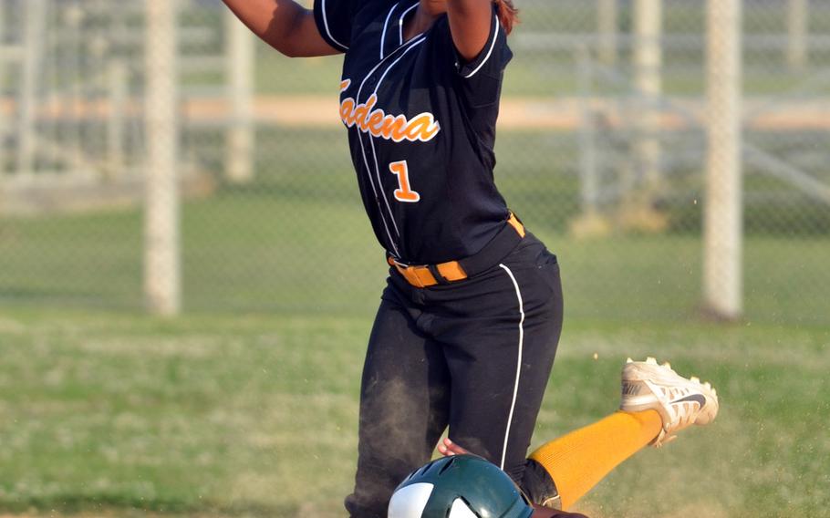 Kubasaki baserunner Roquandra Johnson slides in safely as the throw to Kadena shortstop Savannah Sparrow is too late to nab her. The Panthers won 8-2.