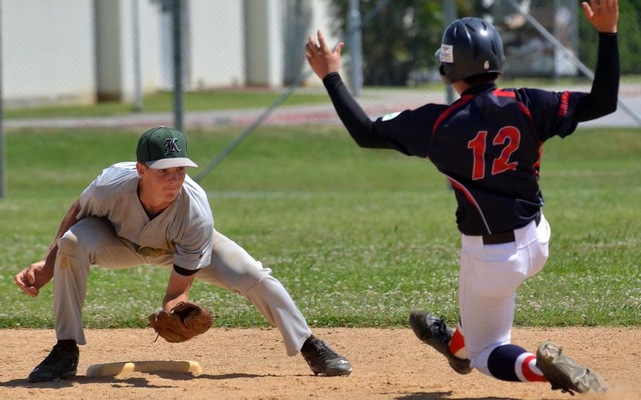 Kubasaki shortstop Hunter Chipman readies a tag on an Okinawa Young Spirit base runner during Saturday's doubleheader at Camp Foster, Okinawa. The Dragons split the twin bill, winning the opener 1-0 and dropping the nightcap 11-2.