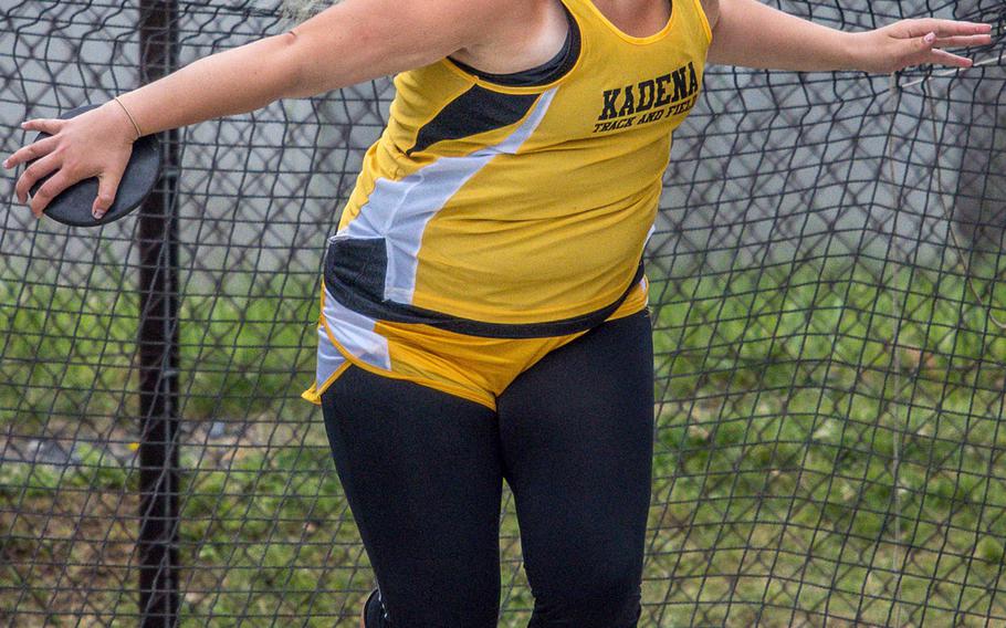 Kadena sophomore Lauren Erp lets hair fly and prepares to let discus fly in Friday's throwing finals. Erp finished fourth with a 27.24; Seoul American's Latisha Dolford took first.
