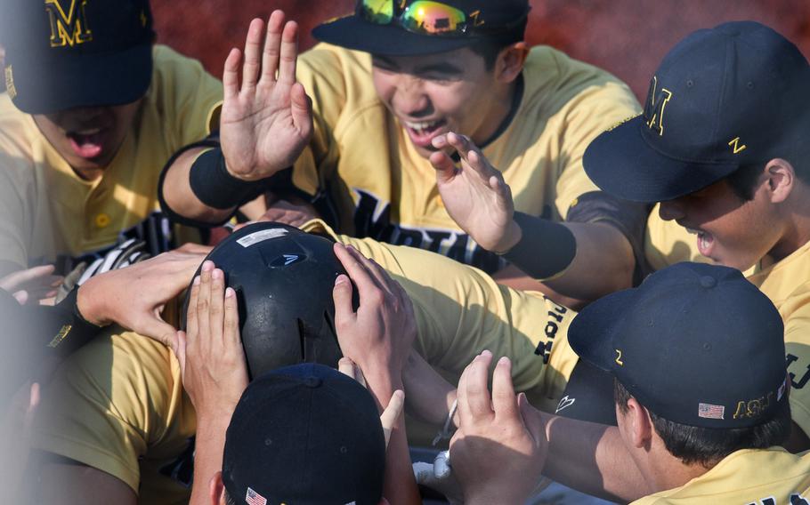 American School In Japan players celebrate a two-run home run by Tyler Sapsford.