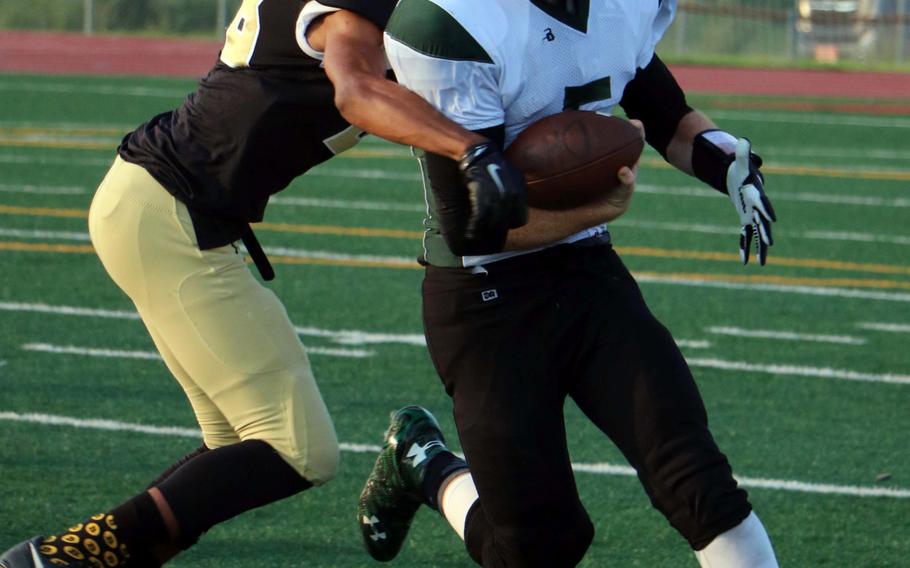 Daegu QB William Bair gets corralled by Tyrell Alexander of Humphreys during the Blackhawks' 27-8 win Friday.