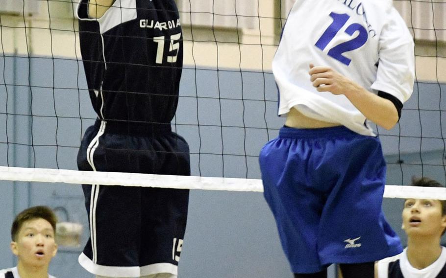 Corban Remsburg of Yongsan battles Seoul American's Jonathan Stewart at the net during the Falcons' four-set victory over the Guardians. The Falcons won 11-25, 25-23, 25-19, 25-16.