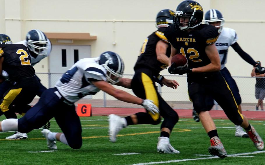 Kadena wingback Owen Sinning looks for running room on one of two reverses he ran for touchdowns against Seoul American.