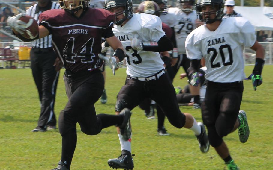 Matthew C. Perry running back Caeleb Ricafrente bulls ahead of Zama  defenders Curtis Blunt and Anthony Ames.