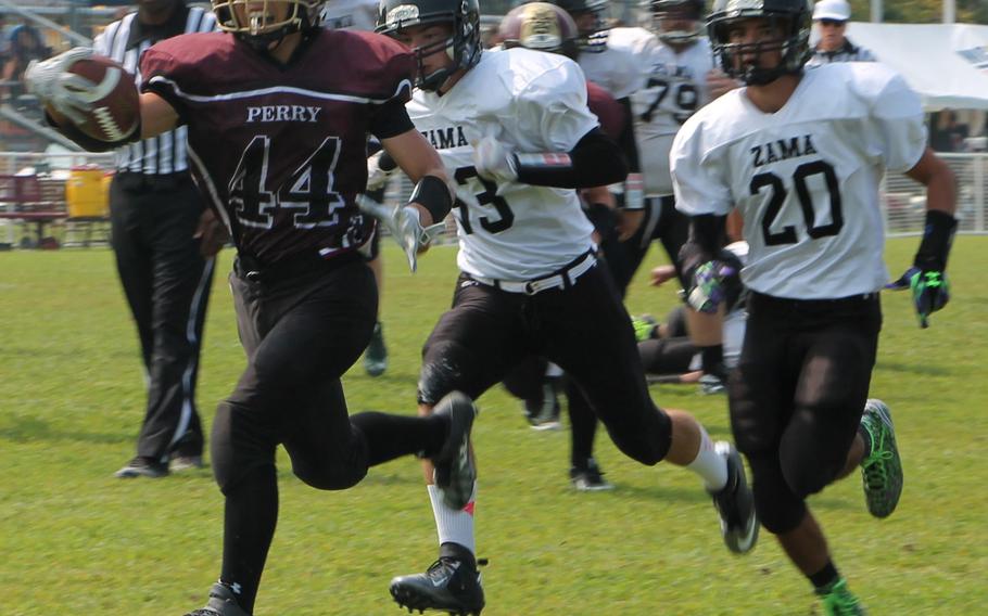 Matthew C. Perry running back Caeleb Ricafrente bulls ahead of Zama defenders Curtis Blunt and Anthony Ames.
