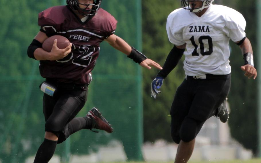 Matthew C. Perry running back Andrew Borrero tries to evade Zama defender Ziaire Johnson.