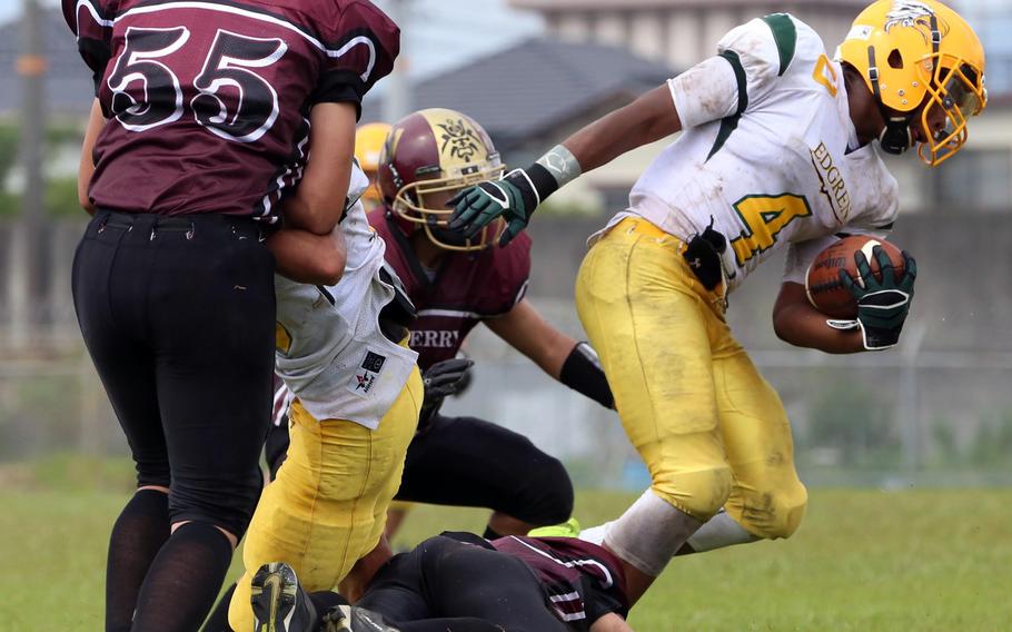 Eli Perez, left, and Matthew C. Perry's defense kept Edgren quarterback Patrick Sledge on the run. But the Eagles couldn't outrun four injuries that prevented them from continuing with 4:23 left in the first half.