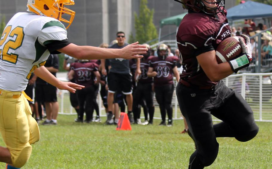 Matthew C. Perry running back Zach Brown reaches the edge against Robert D. Edgren defender Mason Bledsoe.