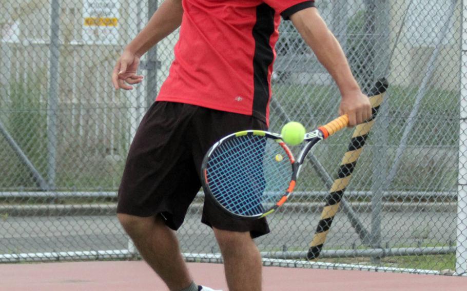 E.J. King's Akira Goodman smacks a backhand against Matthew C. Perry's Nathan Bokamper in Saturday's boys singles match at Marine Corps Air Station Iwakuni. They played to an 8-8 draw and the Cobras beat the Samurai 4-2 with the one draw.