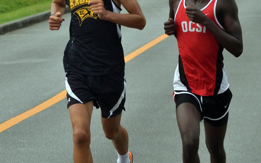 Side by side at the halfway point of Wednesday's Okinawa cross country race are eventual winner Guy Renquist of Kadena and runner-up Tony Wachira of Okinawa Christian.