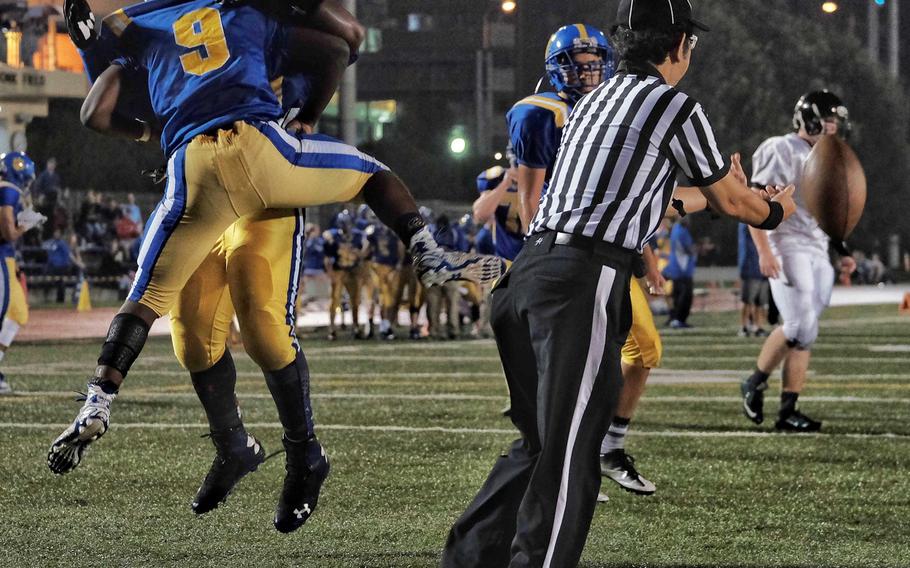 Shomari Tindal, left, celebrates 6-yard touchdown run with a Yokota teammate.