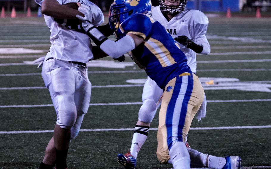 Zama running back Ziaire Johnson attempts to break a Yokota defender's tackle during the final seconds of a 41-6 loss to the host Panthers at Yokota Air Base, Japan on Friday, Sept. 23, 2016. 