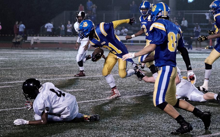 Yokota punt returner Marquis Smith-Brown dances and breaks tackles en route to a 25-yard punt return against the visiting Zama Trojans on Friday, Sept. 23, 2016 at Yokota Air Base, Japan. The return was called back to the Panthers own 7-yard-line after a penalty.  