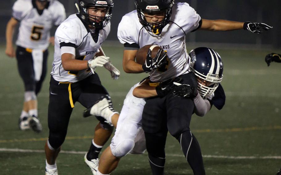 American School In Japan running back Yoshiki Takahashi bulls his way forward for yardage against Seoul American during Saturday's game. The Mustangs blanked the Falcons 35-0.